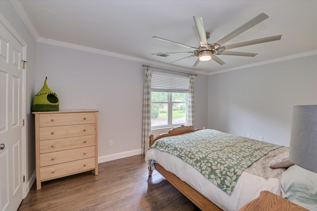 bedroom with dark wood-style floors, ornamental molding, baseboards, and ceiling fan