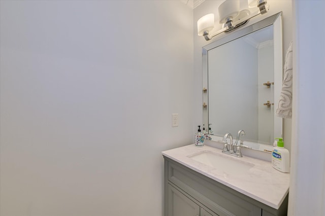 bathroom featuring ornamental molding and vanity