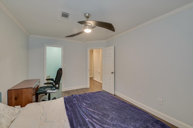 bedroom with crown molding, wood finished floors, baseboards, and a ceiling fan