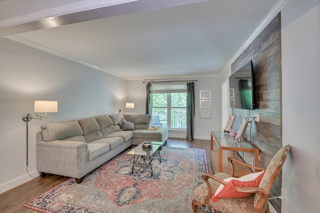 living area featuring baseboards, crown molding, and wood finished floors