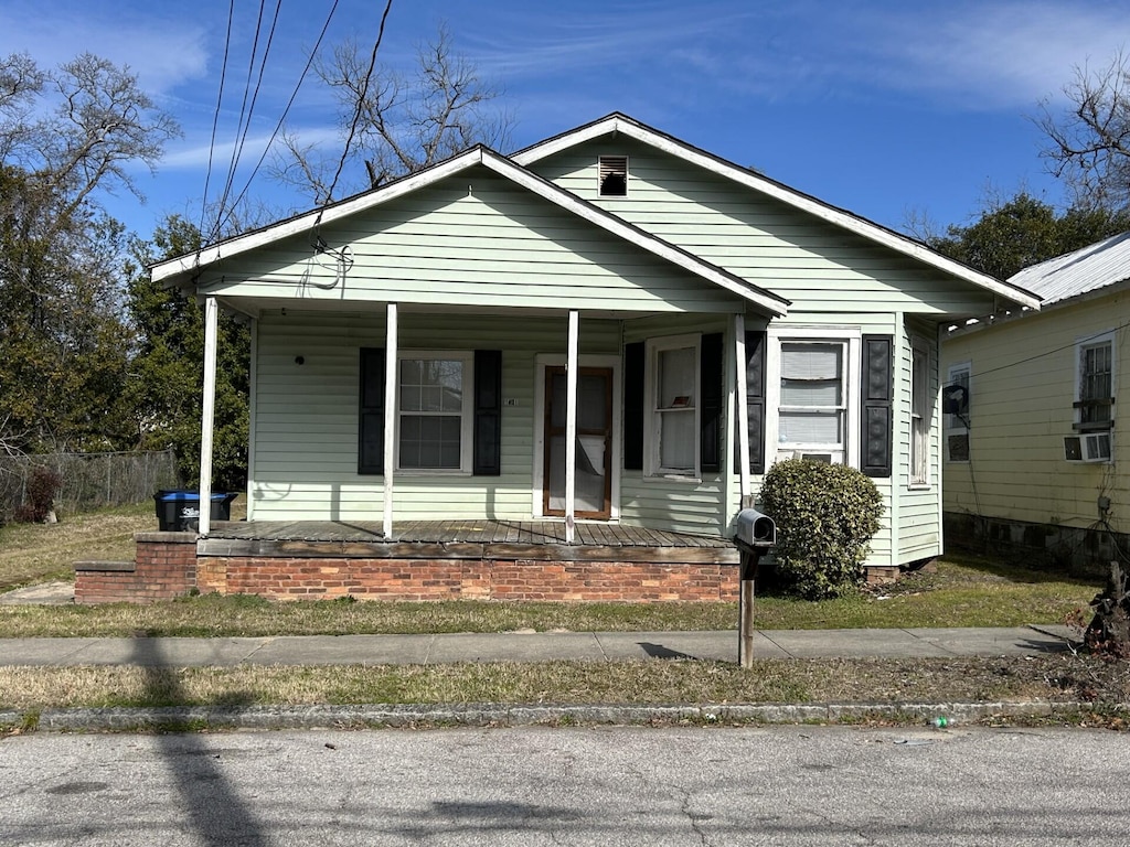 bungalow with cooling unit and covered porch