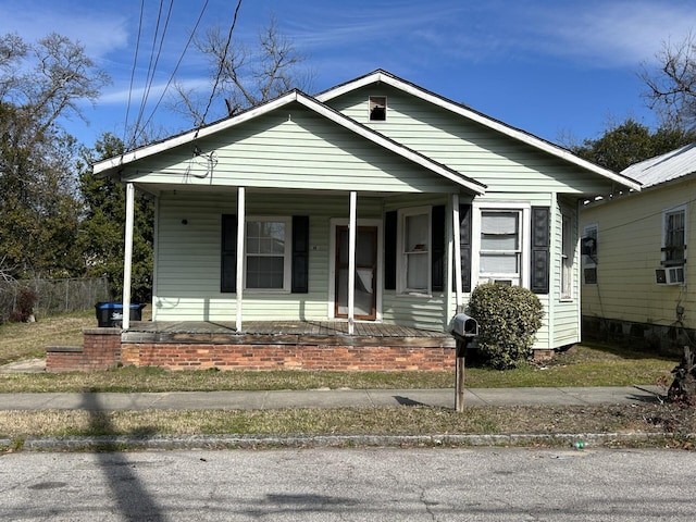 bungalow with cooling unit and covered porch