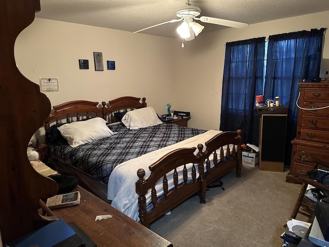 bedroom featuring ceiling fan, carpet flooring, and a textured ceiling