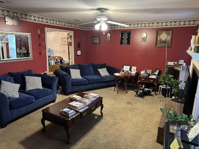 carpeted living room featuring ceiling fan and a textured ceiling