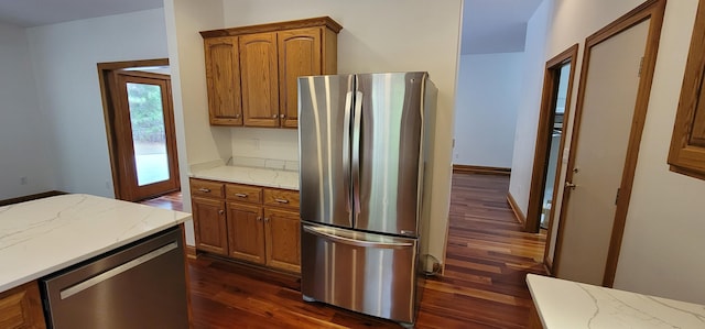 204 Alston Pl, Mccormick, SC 29835 - kitchen featuring appliances with stainless steel finishes, dark wood-style flooring, brown cabinets, and light stone countertops