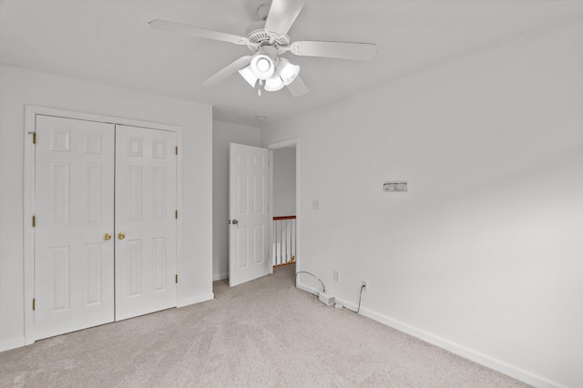2532 Grier Cir, Evans, GA 30809 - unfurnished bedroom with light carpet, baseboards, a closet, and a ceiling fan