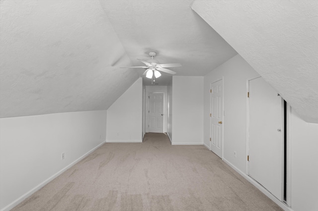 2532 Grier Cir, Evans, GA 30809 - additional living space featuring a textured ceiling, baseboards, light colored carpet, a ceiling fan, and lofted ceiling