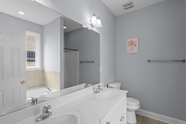 2532 Grier Cir, Evans, GA 30809 - bathroom with tile patterned floors, toilet, double vanity, a garden tub, and baseboards