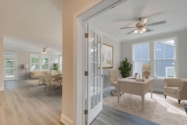 sitting room with ornamental molding, ceiling fan, light wood-type flooring, and french doors