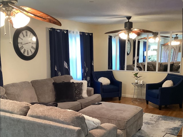 living room featuring ceiling fan and hardwood / wood-style flooring