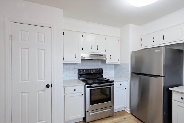 kitchen with stainless steel appliances, light countertops, white cabinets, and under cabinet range hood