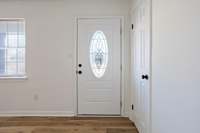 entrance foyer with baseboards and wood finished floors