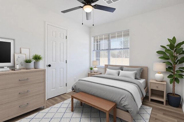 bedroom with light wood-type flooring and a ceiling fan