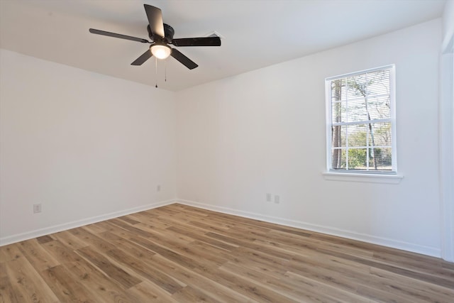 unfurnished room featuring light wood-type flooring, ceiling fan, and baseboards