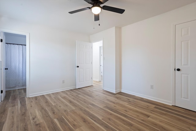 unfurnished bedroom featuring ceiling fan, baseboards, and wood finished floors