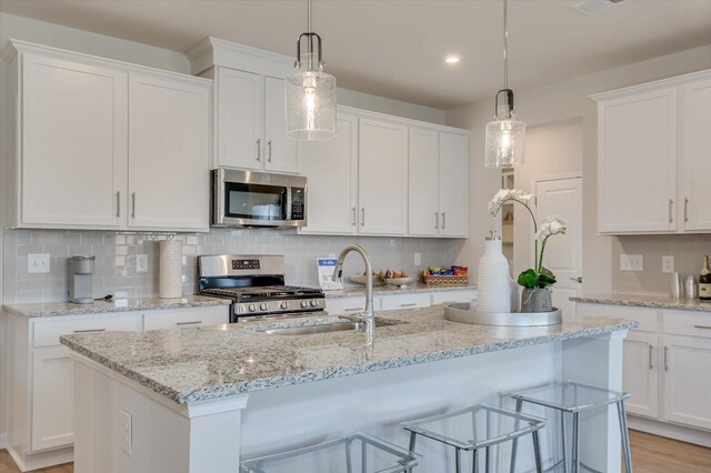 188 Scruple Way, North Augusta, SC 29860 - kitchen with backsplash, white cabinetry, appliances with stainless steel finishes, and a sink