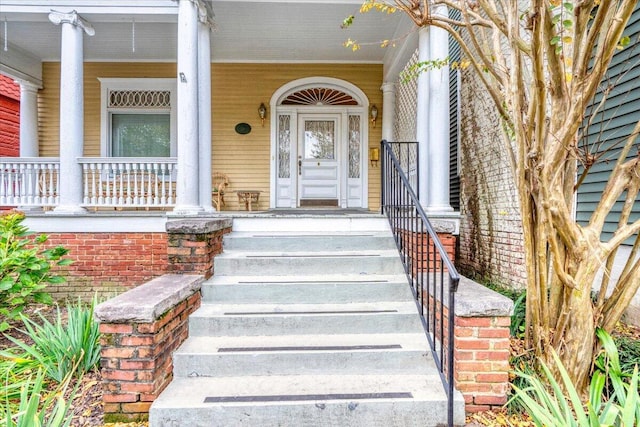 view of exterior entry with a porch