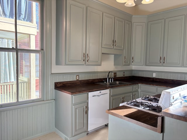 kitchen with butcher block countertops, dishwasher, and sink