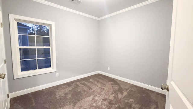 empty room featuring ornamental molding and carpet