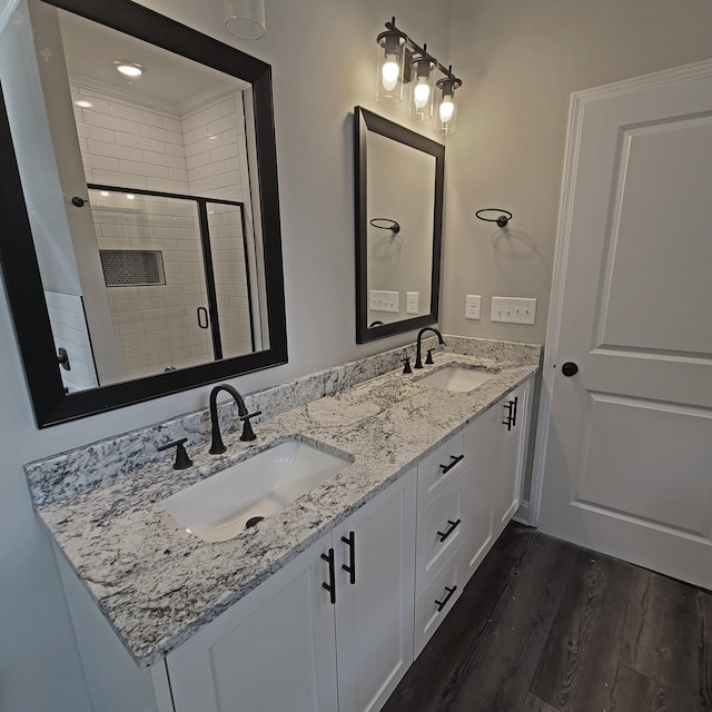 556 Hillman St, Warrenville, SC 29851 - bathroom featuring a stall shower, double vanity, and wood finished floors