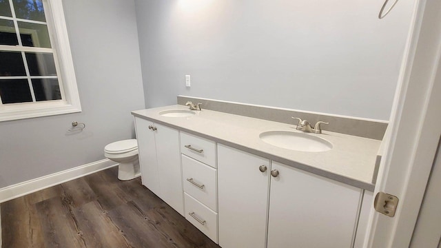 bathroom with vanity, wood-type flooring, and toilet