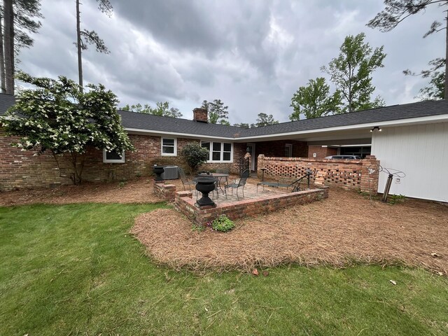 3517 Jamaica Dr, Augusta, GA 30909 - rear view of property featuring a patio area, a chimney, brick siding, and a fire pit