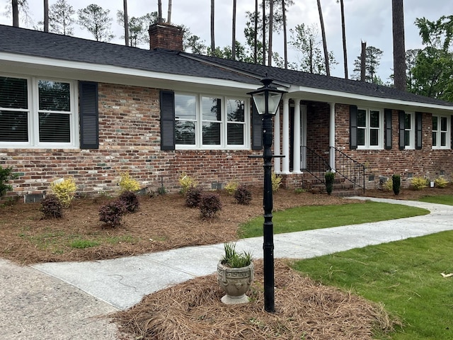 3517 Jamaica Dr, Augusta, GA 30909 - ranch-style home with brick siding, a chimney, crawl space, and a front lawn