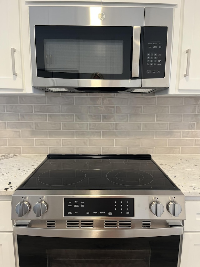 3517 Jamaica Dr, Augusta, GA 30909 - kitchen view of stainless steel appliances, white cabinets, backsplash, and light stone counters