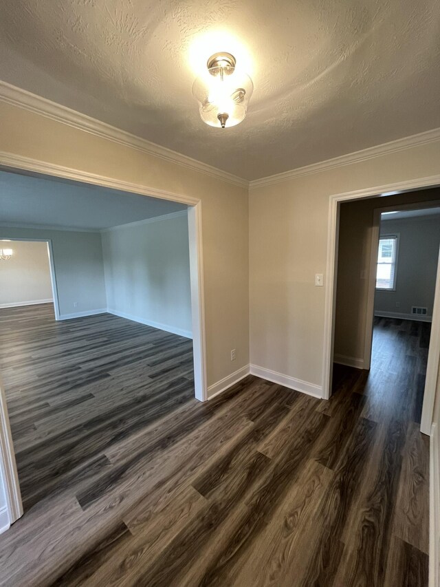 3517 Jamaica Dr, Augusta, GA 30909 - unfurnished room with crown molding, dark wood finished floors, a textured ceiling, and a chandelier