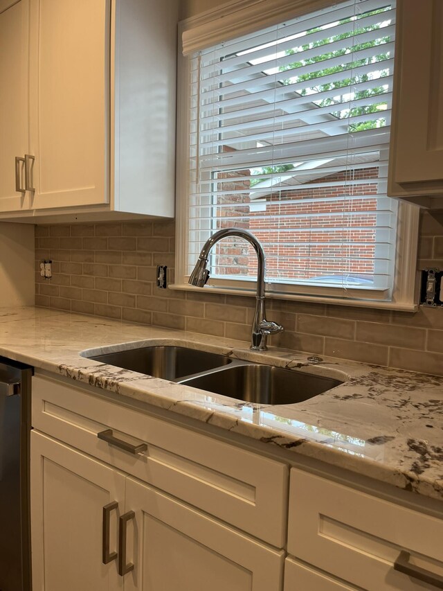 3517 Jamaica Dr, Augusta, GA 30909 - kitchen with white cabinetry, stainless steel dishwasher, backsplash, and light stone counters