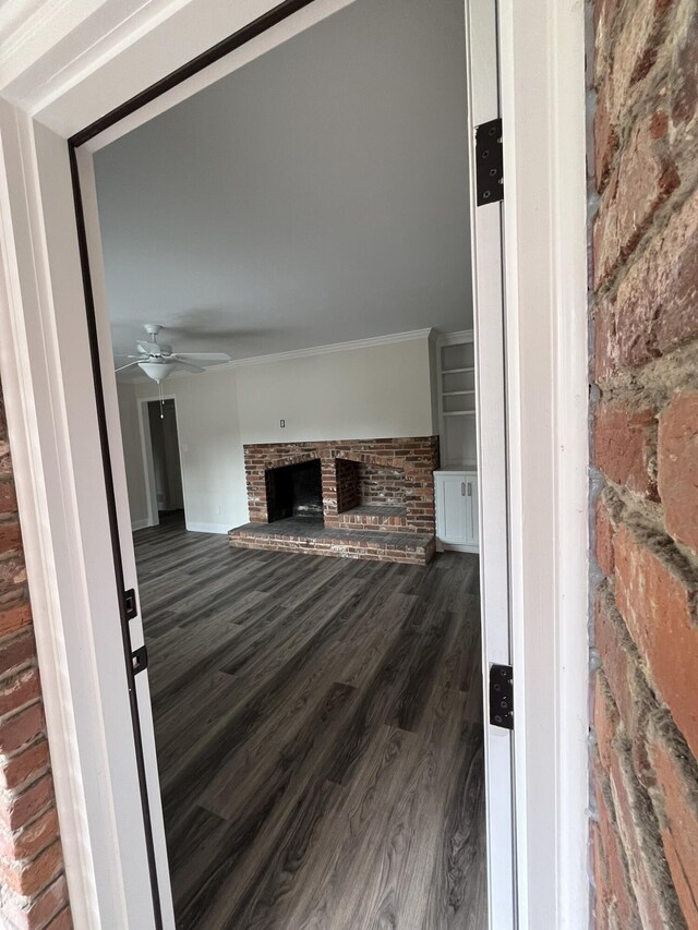3517 Jamaica Dr, Augusta, GA 30909 - unfurnished living room featuring a fireplace, wood finished floors, a ceiling fan, and ornamental molding