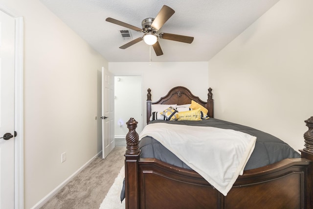 carpeted bedroom with a textured ceiling and ceiling fan