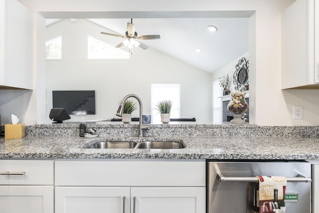 kitchen with dishwasher, a healthy amount of sunlight, white cabinets, and lofted ceiling