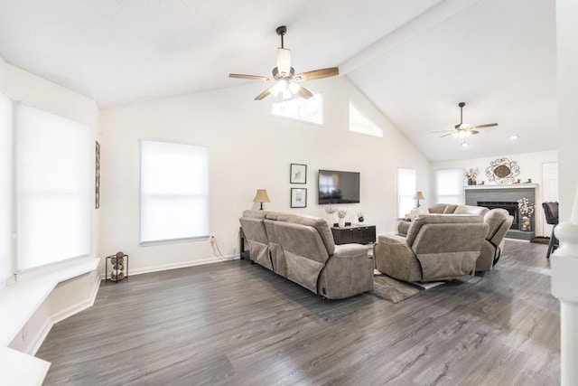 living room featuring ceiling fan, a fireplace, beamed ceiling, and dark hardwood / wood-style floors