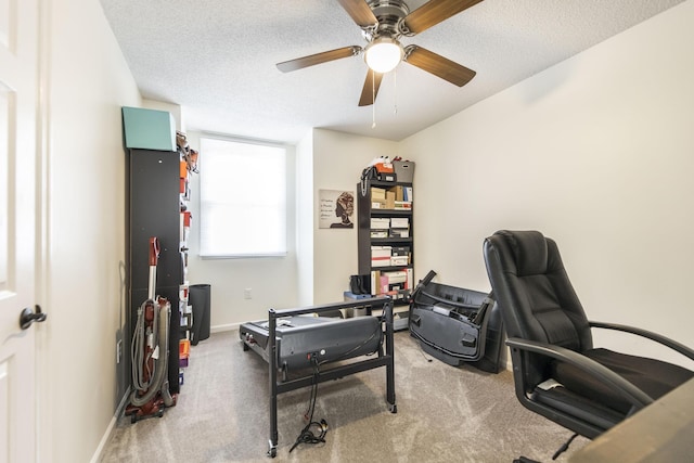 office area featuring ceiling fan, carpet floors, and a textured ceiling