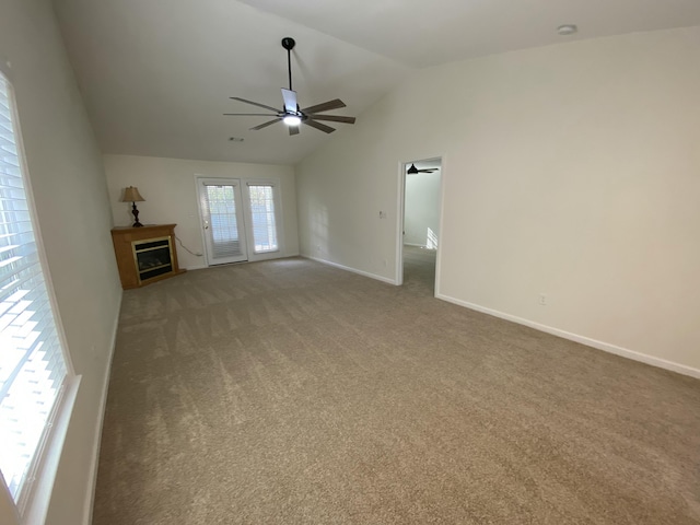 unfurnished living room featuring ceiling fan, carpet floors, and lofted ceiling