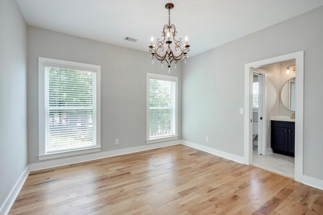 110 Collin Reeds Rd, North Augusta, SC 29860 - unfurnished room with a chandelier, light wood-style floors, and baseboards