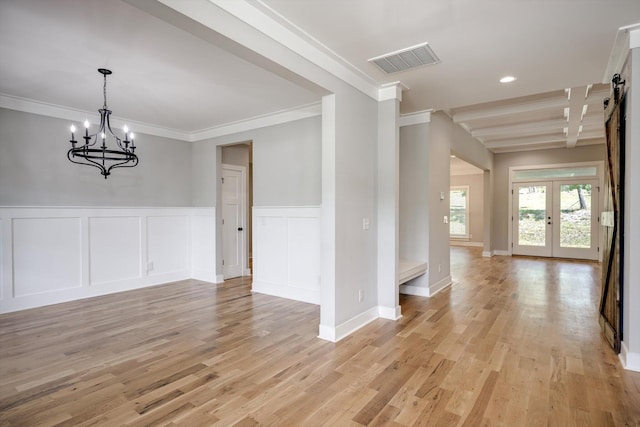110 Collin Reeds Rd, North Augusta, SC 29860 - unfurnished dining area with crown molding, a chandelier, light wood-style flooring, a wainscoted wall, and a decorative wall