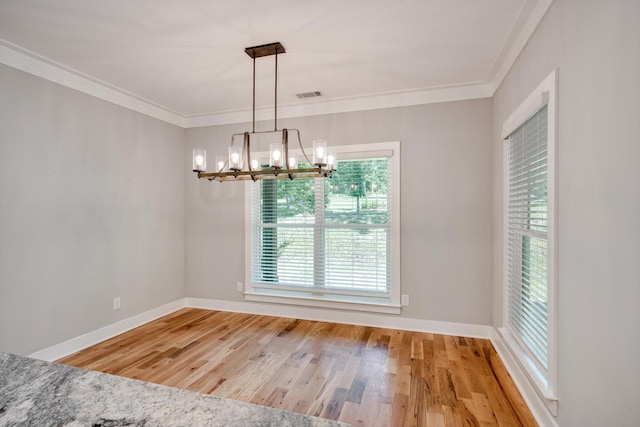 110 Collin Reeds Rd, North Augusta, SC 29860 - unfurnished dining area with a chandelier, wood finished floors, crown molding, and baseboards