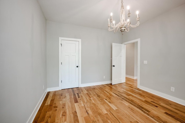 110 Collin Reeds Rd, North Augusta, SC 29860 - spare room featuring a chandelier, light wood-style floors, and baseboards