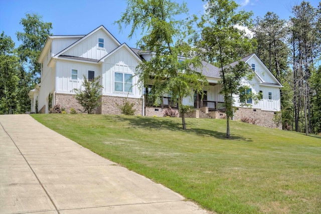 110 Collin Reeds Rd, North Augusta, SC 29860 - modern farmhouse style home featuring board and batten siding, a front yard, brick siding, and a porch