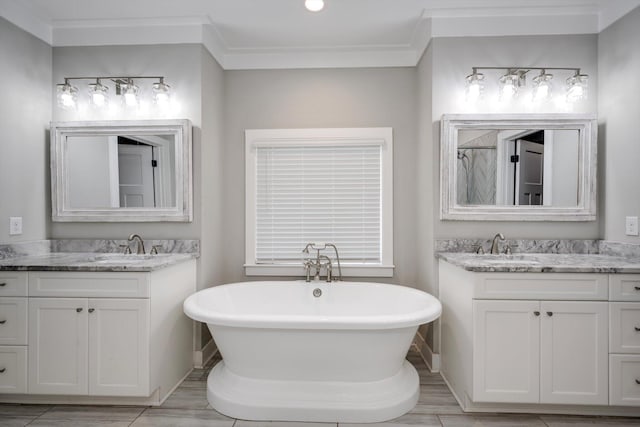 110 Collin Reeds Rd, North Augusta, SC 29860 - bathroom featuring two vanities, a soaking tub, crown molding, baseboards, and a shower