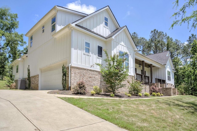 110 Collin Reeds Rd, North Augusta, SC 29860 - view of home's exterior with board and batten siding, brick siding, covered porch, a garage, and a lawn