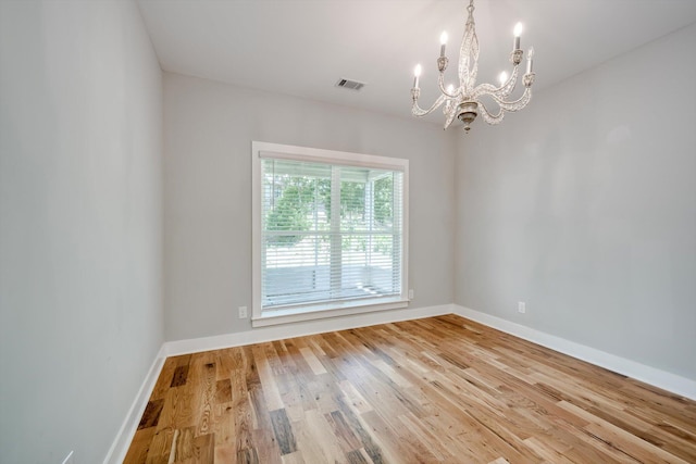 110 Collin Reeds Rd, North Augusta, SC 29860 - unfurnished room featuring a chandelier, light wood finished floors, and baseboards