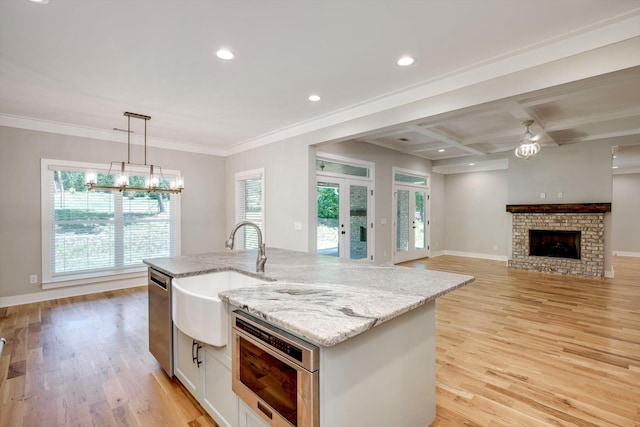 110 Collin Reeds Rd, North Augusta, SC 29860 - kitchen featuring a sink, stainless steel dishwasher, light stone counters, light wood finished floors, and hanging light fixtures
