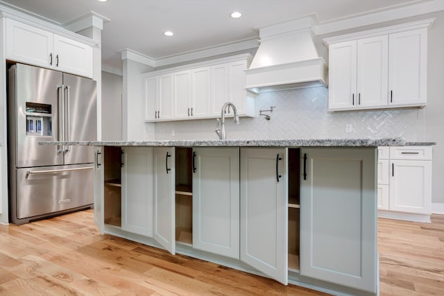 110 Collin Reeds Rd, North Augusta, SC 29860 - kitchen with high quality fridge, custom exhaust hood, ornamental molding, tasteful backsplash, and light wood-style flooring