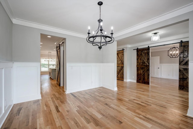 110 Collin Reeds Rd, North Augusta, SC 29860 - unfurnished dining area with a barn door, a chandelier, a decorative wall, ornamental molding, and light wood finished floors