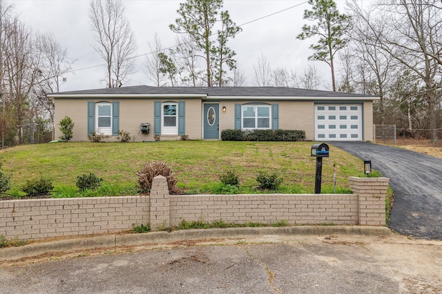 ranch-style house featuring aphalt driveway, a front lawn, fence, and a garage