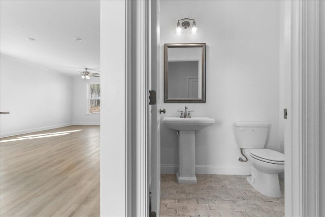 bathroom with ceiling fan, wood-type flooring, toilet, and sink