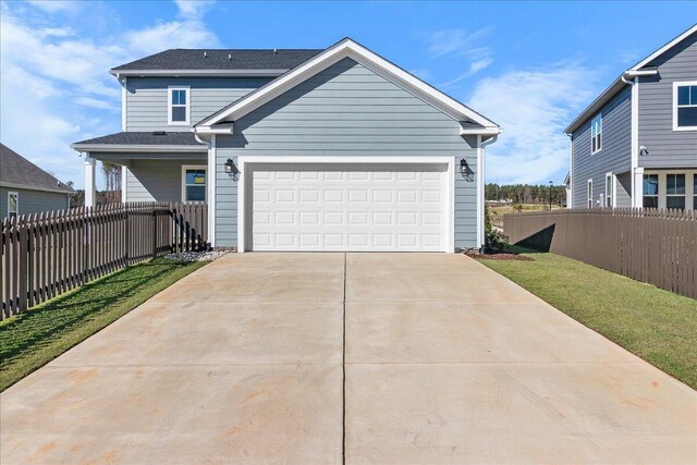 view of front of property with a garage and a front lawn